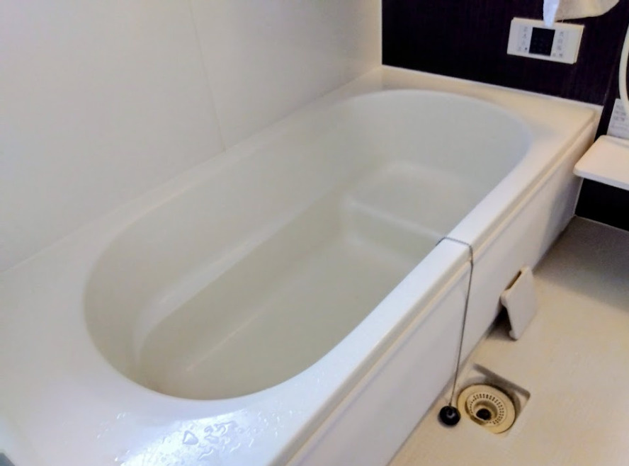 一日の疲れを癒す広々とした浴槽です。半身浴も楽しめるベンチ付きで、快適なバスタイムを演出します。