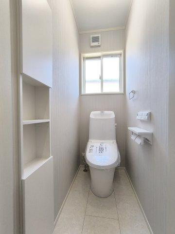 【トイレ】1階・2階ともに温水洗浄暖房便座を採用。便器はフチがない形状なので、黒ずみ汚れが付きにくくお手入れ楽々！壁には埋め込み収納もあるので、トイレットペーパー等を収納できます。