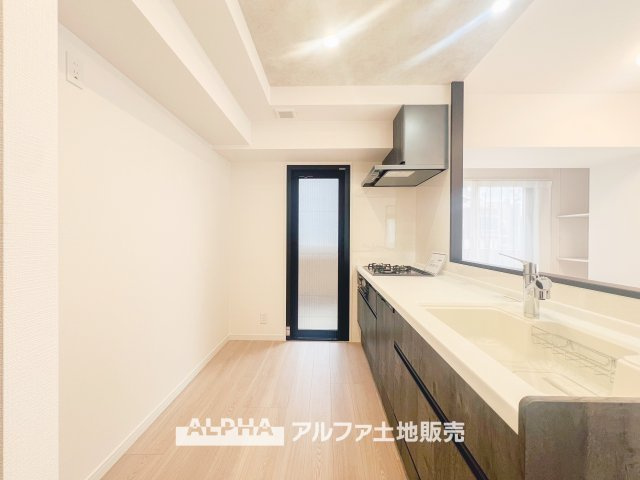 白を基調にしたシンプルで清潔感あふれるキッチン。3口ガスコンロと食器洗い乾燥機が完備され、効率よく料理が進められます。収納も充実しており、整理整頓がしやすいのが特徴です。