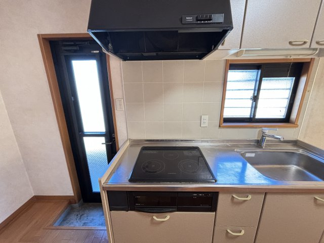 勝手口のある便利なキッチンは換気もしやすく日常の家事が効率的にこなせる造り。IHクッキングヒーター付で安全性も高く調理スペースも広めで作業がしやすいのが特徴です。窓から光が入り清潔感のあるキッチンです