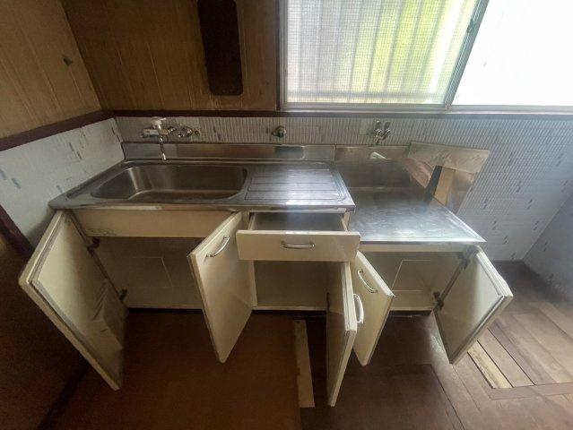 窓に面して設けられたキッチンは、自然光を取り込みやすく換気もしやすい配置。シンクや調理スペースを確保し、上下には収納スペースも備えています。窓から明るさを取り込める、使い勝手を考えたキッチンスペース。