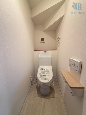 【トイレ】背面にはちょっとしたカウンターがあり、小物やストック品を置くのにも便利。換気口も備わっており、空気のこもりを防ぎながら快適に保てます。