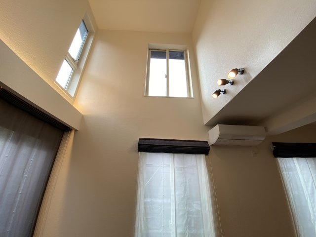 上下階をゆるやかにつなぐ吹抜け設計。高窓からの採光で、時間帯によって異なる表情を楽しめます。開放感がありながらも冷暖房効率にも配慮された設計で、デザイン性と機能性を兼ね備えています。