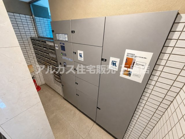 ダイヤル式の集合ポストと宅配ボックスが設置されたエリア。不在時でも荷物を受け取れる便利な設備が整っています。
