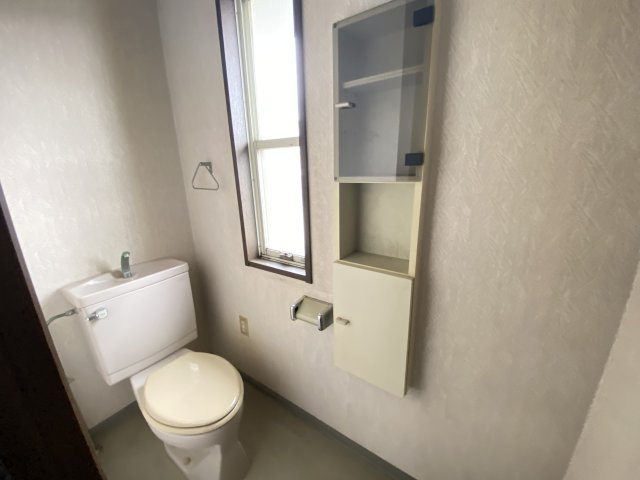 2階に設けられたトイレは、窓付きで明るく換気もしやすい快適な空間です。手洗い一体型のタンクで省スペースを実現し、収納棚も備えているため、トイレットペーパーや小物類の保管にも便利です。