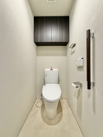 清潔感のあるトイレ。背面上部には収納棚もあり、トイレ用品をしまっておく事ができるのは便利ですね。