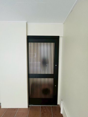 採光デザインの玄関ドアです。道路からは見えづらいガレージの中にあるため、お家の中が見えてしまう心配はあまりありません。