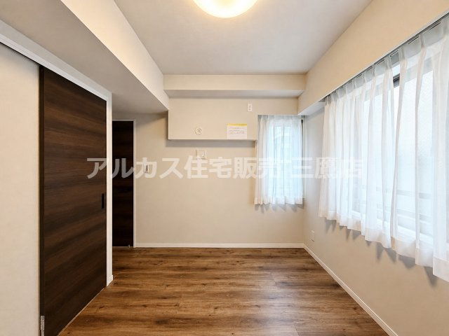 2面に窓が配置された採光性の高い洋室。落ち着いたトーンのフローリングとシンプルなクロスで使い勝手の良い室内です。