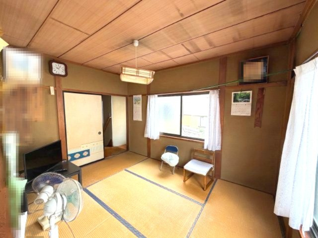 木目の天井と畳が調和した、趣のある2階和室。窓から光が差し込み、ゆったり寛げる落ち着いた空間です。