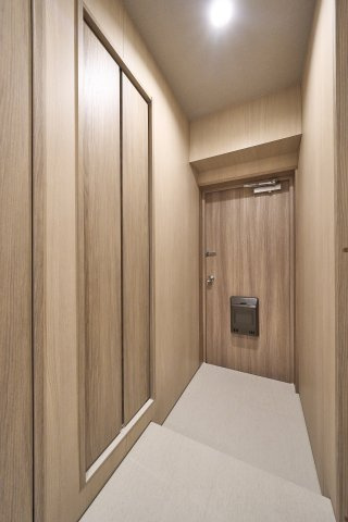 落ち着いたトーンの内装と収納を備えたすっきりとした玄関。シューズボックスへ靴類をしっかりと整理でき、住まいの顔として清潔感と上品な印象を与えるアプローチとなっています。