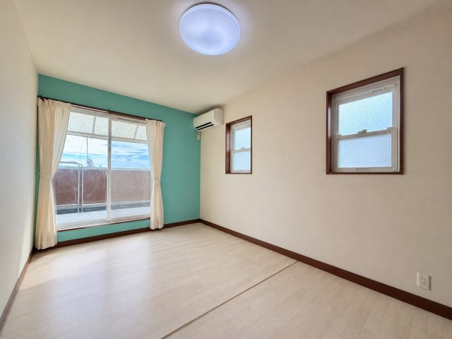 ターコイズの壁がアクセントの明るい洋室。子供部屋にもぴったりです。※写真は家具消し加工しております。