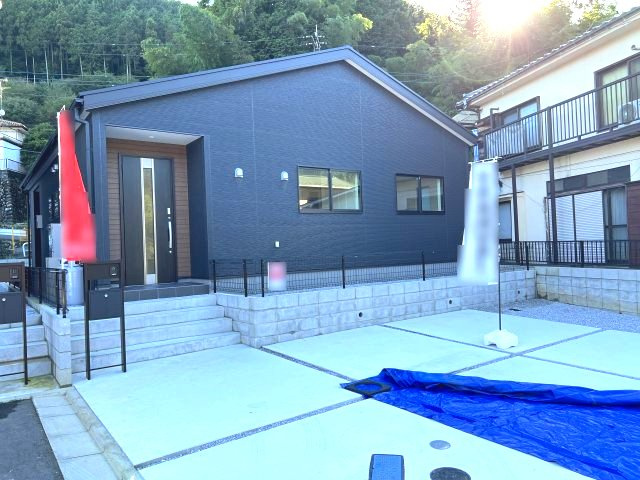 シックな外壁に木目調の玄関が映える、スタイリッシュな平屋住宅。ワンフロアで生活が完結し、階段の上り下りがないスムーズな動線が魅力です。