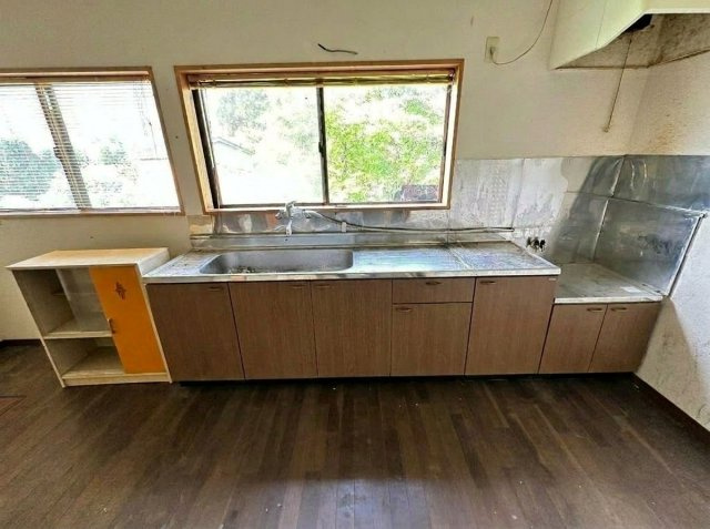 壁面に窓を配置した明るいキッチンです。下に収納があります