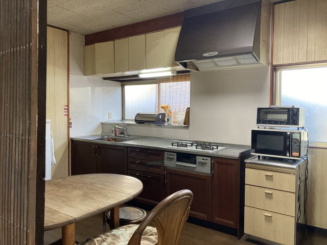 木目の温もりを感じる古民家風のキッチンは、どこか懐かしく落ち着いた雰囲気が魅力。窓からの自然光が手元を明るく照らし、日々の家事も快適に行えます。収納も豊富で調理器具や食器類もすっきり整理可能。