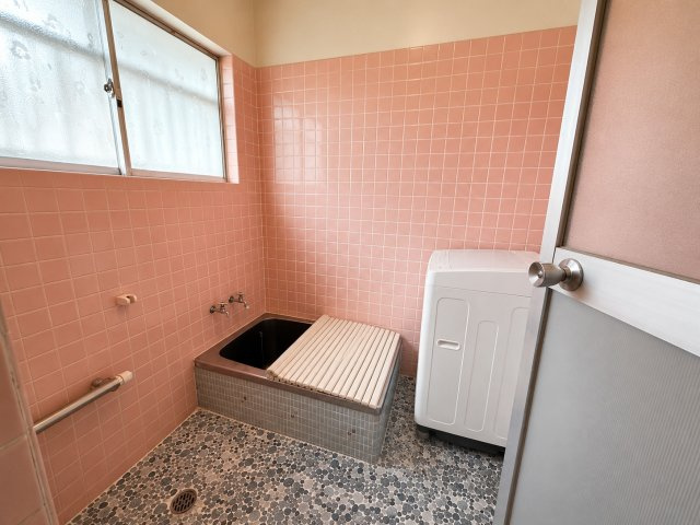 やさしいピンク色のタイルが印象的な浴室です。窓付きのため換気がしやすく、湿気がこもりにくいのも嬉しいポイント。どこか懐かしさを感じるレトロな雰囲気があり、ゆったりと一日の疲れを癒せる空間です。