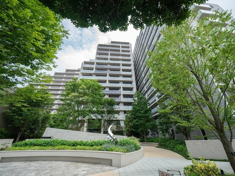 【Mansion　exterior】白系モノトーンの外壁に基壇部を包み込む緑が清涼感を感じさせます。