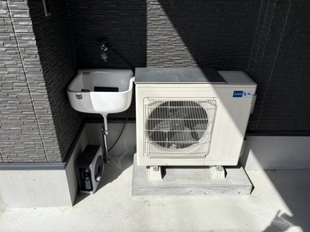 屋外には便利なシンク付きの水栓を設置。靴の汚れを落としたり、車の洗浄やガーデニングなど多目的に活用できます。シンプルなデザインながらも清潔感があり、使い勝手の良い位置に配置されています。