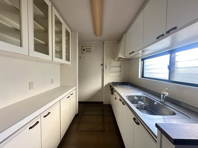 調理スペースと収納をしっかり確保したキッチン。上下に収納棚があり、食器や調理器具を整理しやすい造りです。窓付きのため自然光が入り、手元が明るく換気もしやすい点が魅力。