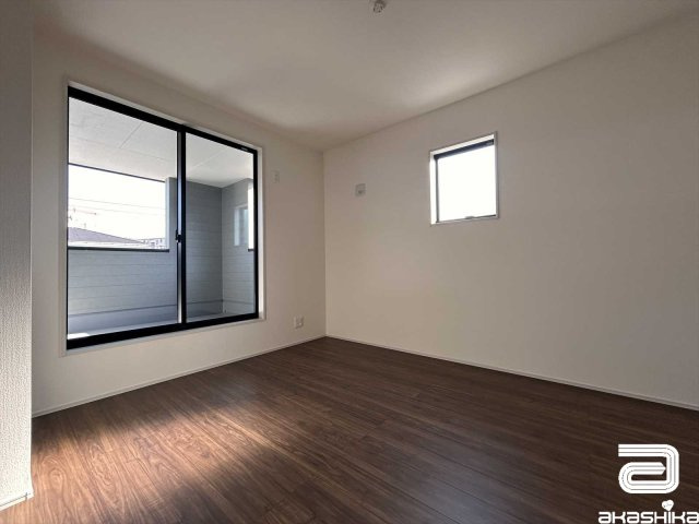 バルコニーに繋がる大きな窓から光が差し込む明るい部屋です。
