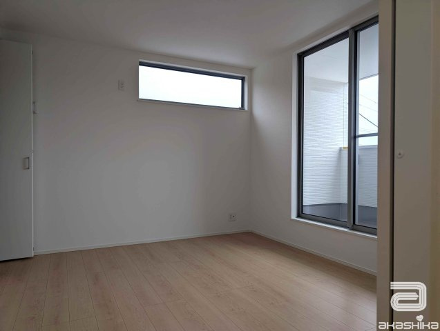 バルコニーに繋がる大きな窓から光が差し込む明るい部屋です。