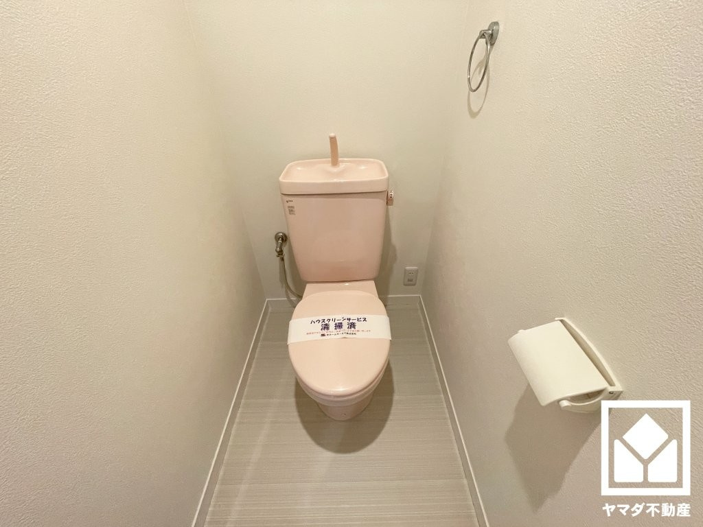 明るく清潔感溢れるトイレです。タオル掛けやペーパーホルダーが設置されています。