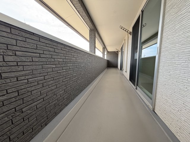 まるで屋外の廊下のように長く伸びたベランダが、室内と外をつなぎ、光と風を住まい全体に届けます。