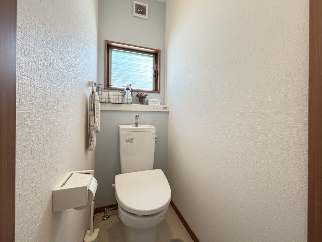 落ち着いた色合いでまとめられたトイレはシンプルで清潔感のある空間です。小窓付きで換気性が高く常に爽やかな状態を保てます。手洗い一体型で使い勝手も良く省スペースながら快適さがしっかり確保されたトイレです