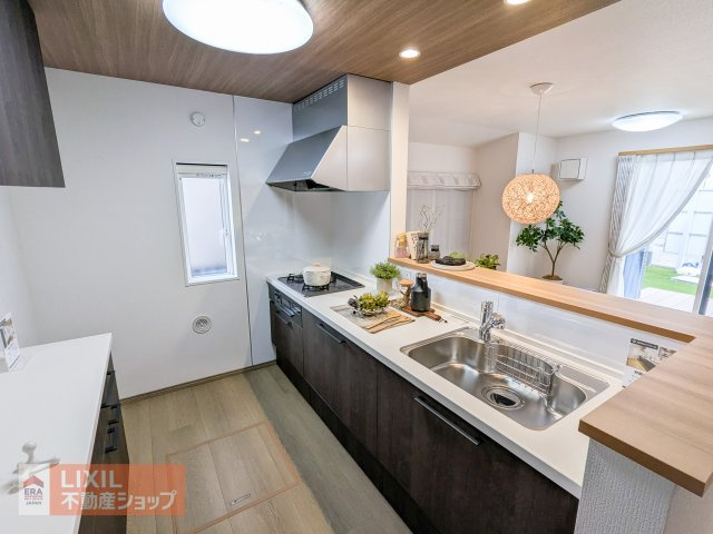 【キッチン】現地完成写真。明るい床材とシックな色合いのキッチンがおしゃれです。後ろの収納も充実の収納力。カウンターキッチンで家族の会話も弾みますね♪