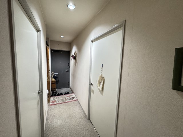室内から見た玄関です。　玄関から廊下にかけては落ち着いた色味で統一され、帰宅時にほっとできる空間です。　一直線の廊下なので家事導線がスムーズで、家族間の移動もしやすそうです。　