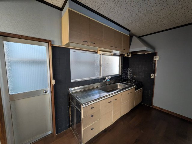 壁付けタイプのキッチンで空間を広く活用可能。収納スペースも上下にしっかり確保されており調理器具や食器の整理にも便利です。窓付きで換気しやすく明るさも感じられる造り。使い勝手の良いシンプルなキッチンです