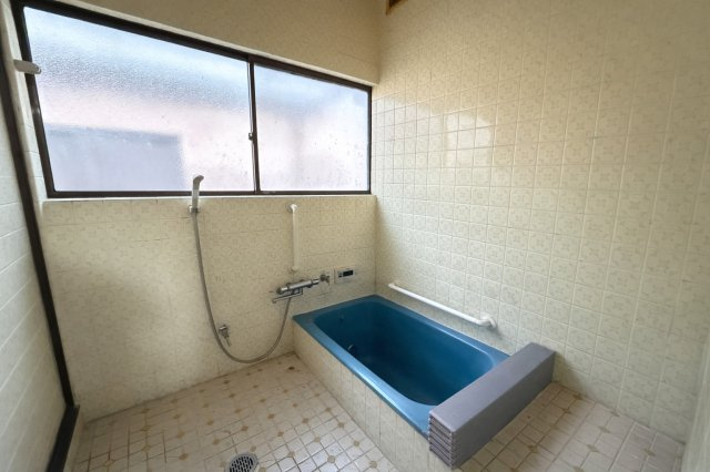 大きな窓を備えた浴室は、自然光が入り明るい空間です。ゆったりとした浴槽で、一日の疲れを癒すことができます。手すりも設置されており、安全面にも配慮された設計です。窓を開けて換気ができるため湿気対策◎