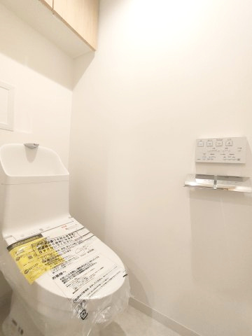 【トイレ】　温水洗浄便座付きのトイレ。操作のしやすいリモコンタイプです。上部には収納付で、トイレットペーパー等、買い置きもしやすそうです。　