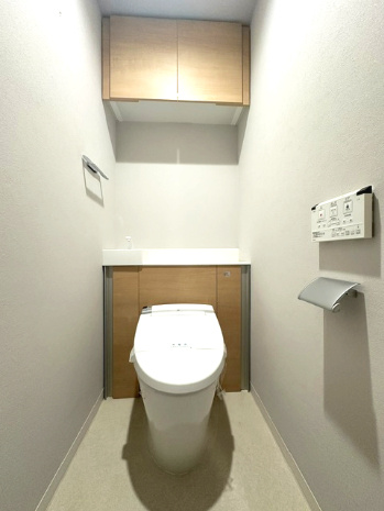温水洗浄便座付のトイレで、冬の寒い時期でも快適！吊戸棚付きで、予備のペーパー類も問題なく収納できます。