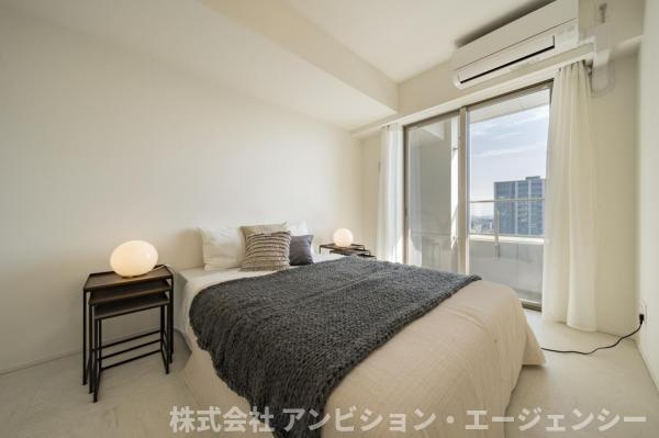 大きな窓から柔らかな光が差し込む主寝室。バルコニー越しに広がる開放的な眺望が、朝の目覚めを彩ります。